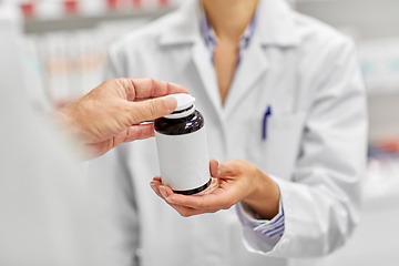 Image showing pharmacist and customer with medicine at pharmacy