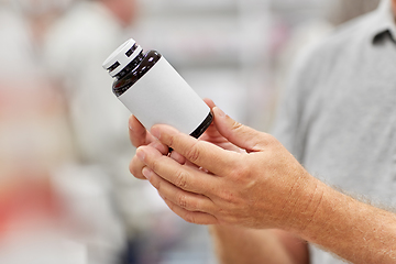 Image showing close up of customer choosing medicine at pharmacy