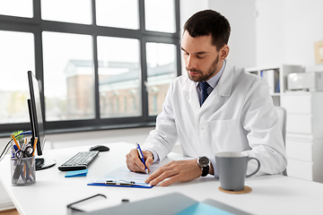 Image showing male doctor with clipboard at hospital