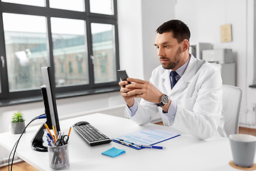 Image showing male doctor with smartphone at hospital