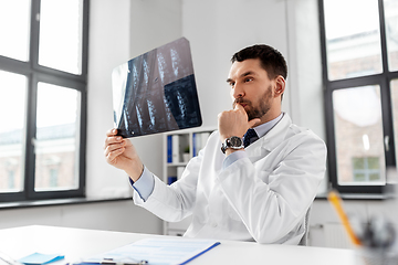 Image showing male doctor with x-ray of spine at hospital