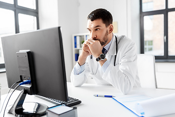 Image showing male doctor with computer working at hospital