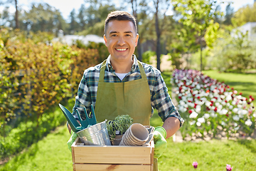 Image showing happy man with tools in box at summer garden