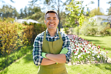 Image showing happy man in apron at summer garden