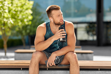 Image showing sportsman with earphones and bottle in city