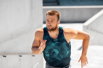 Image showing young man running upstairs