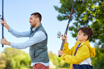 Image showing happy smiling father and son fishing on river