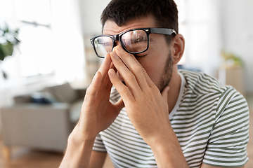 Image showing tired man with glasses at home office