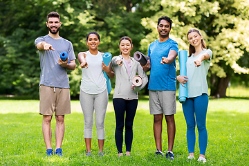 Image showing group of happy people with yoga mats at park