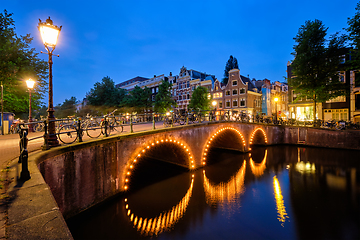 Image showing Amterdam canal, bridge and medieval houses in the evening