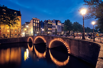 Image showing Amterdam canal, bridge and medieval houses in the evening