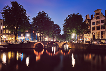 Image showing Amterdam canal, bridge and medieval houses in the evening