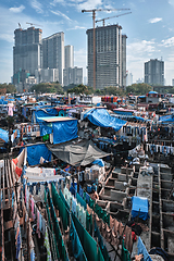 Image showing Dhobi Ghat is an open air laundromat lavoir in Mumbai, India with laundry drying on ropes