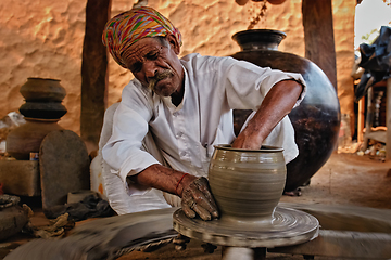 Image showing Indian potter at work. Handwork craft from Shilpagram, Udaipur, Rajasthan, India