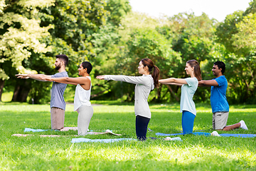 Image showing group of people doing yoga at summer park