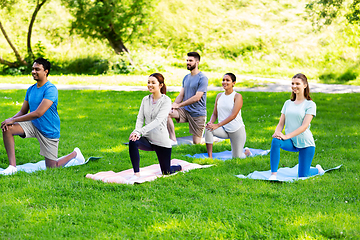 Image showing group of people doing yoga at summer park