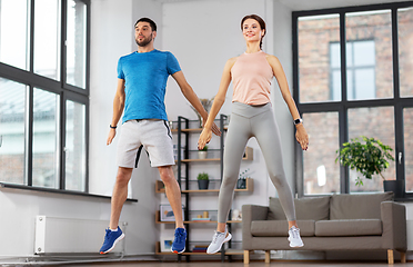 Image showing happy couple exercising at home