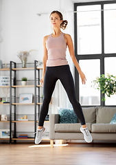 Image showing young woman exercising at home