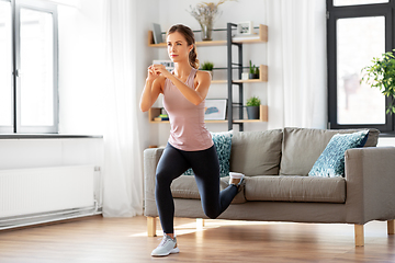 Image showing young woman exercising at home