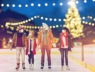 Image showing friends in masks on christmas skating rink