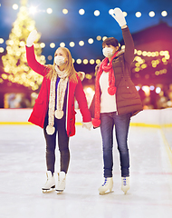 Image showing women in masks at christmas skating rink