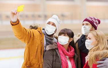 Image showing friends in masks taking selfie on skating rink