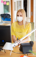 Image showing businesswoman in mask with computer at office