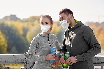Image showing couple in mask with bottles of water training