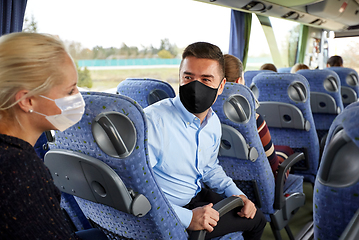 Image showing passengers in masks talking in travel bus