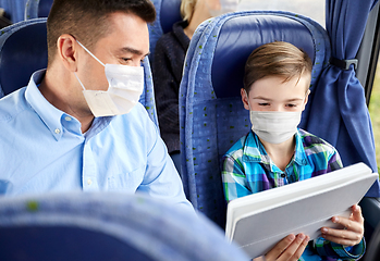 Image showing family in masks with tablet pc in travel bus