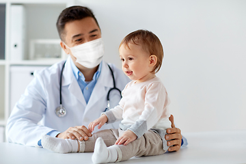 Image showing doctor or pediatrician in mask with baby at clinic