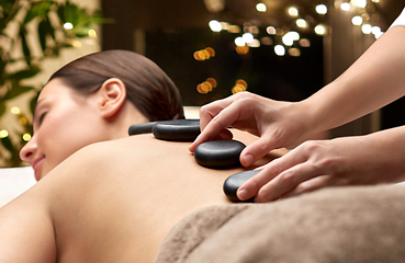 Image showing close up of woman having hot stone massage at spa