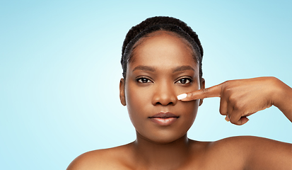 Image showing portrait of african woman pointing to her nose