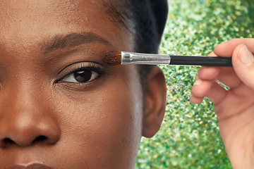 Image showing face of african woman and hand with make up brush