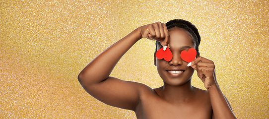 Image showing smiling african american woman with red hearts