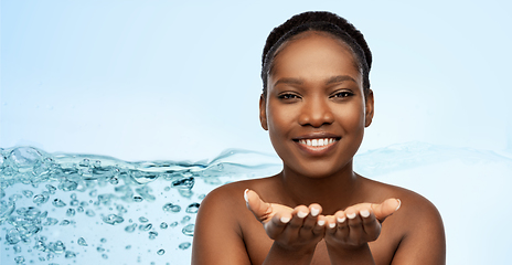 Image showing happy african american woman holding something