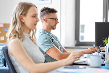 Image showing male creative worker with laptop working at office