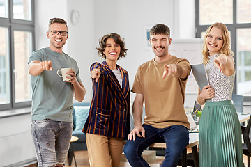 Image showing business team pointing fingers to camera at office