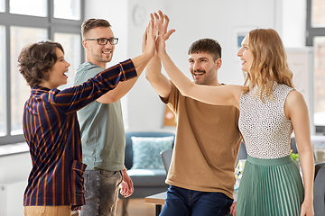 Image showing happy business team making high five at office