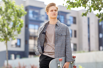 Image showing teenage boy with skateboard on city street