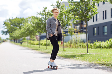 Image showing teenage boy on skateboard on city street