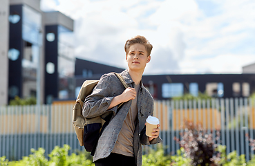 Image showing young man with backpack drinking coffee in city