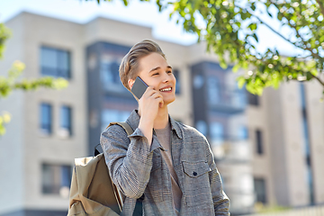 Image showing teenage student boy calling on smartphone in city