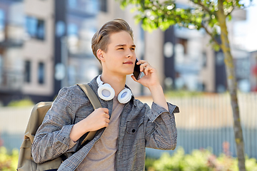 Image showing teenage student boy calling on smartphone in city