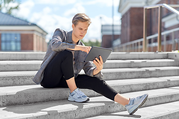 Image showing young manor teenage boy with tablet pc in city