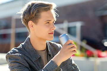 Image showing young man with drink in tin can in city