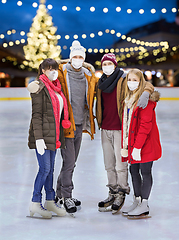 Image showing friends in masks at christmas skating rink