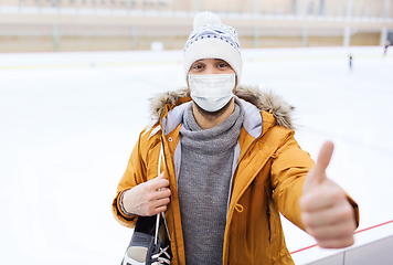 Image showing man in mask showing thumbs up on skating rink