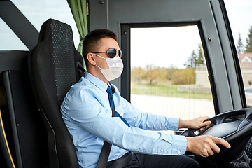 Image showing male driver in mask driving intercity bus