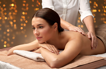 Image showing woman lying and having back massage at spa